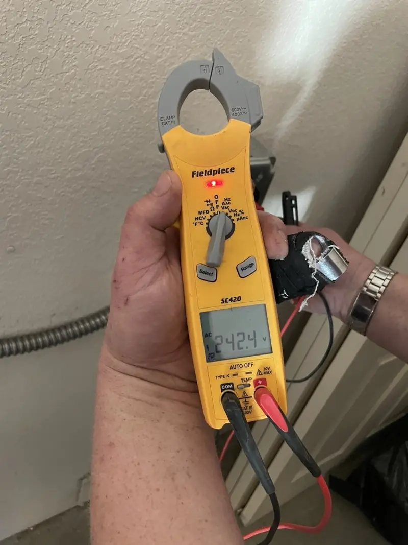 Voltage testing with clamp meter during Outlet Installation in Fort Mitchell